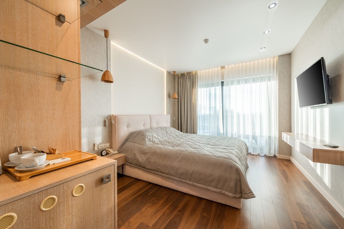 Inviting hotel room with comfortable bedding and ambient lighting.