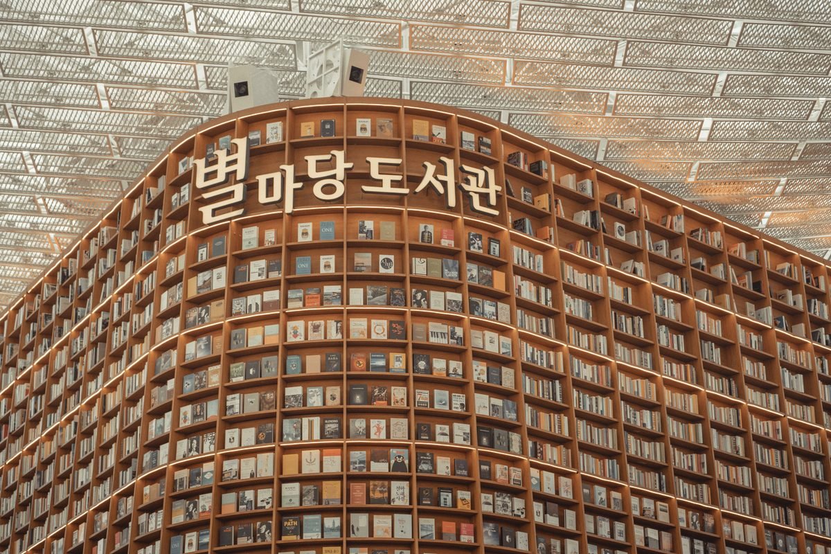 Towering bookshelves with Korean signage at Starfield Library in Seoul
