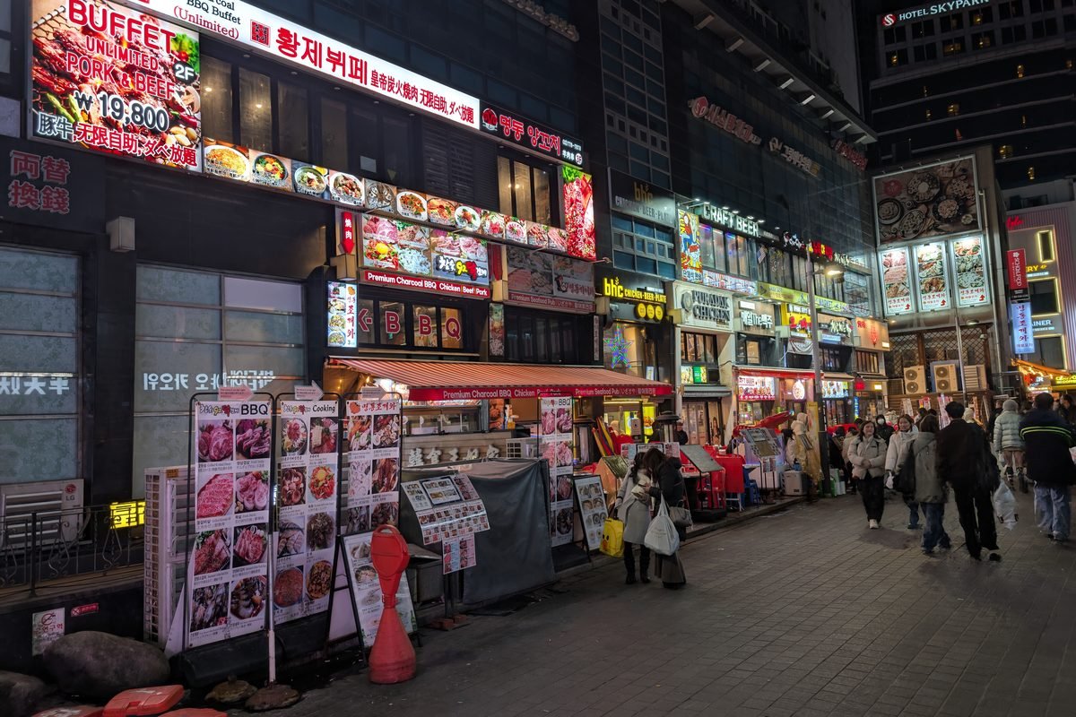 Vibrant street view in Seoul featuring restaurants and colorful night market signs