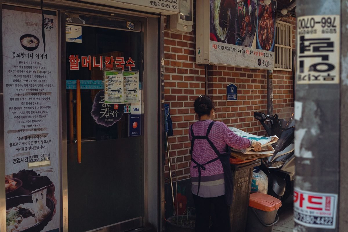 Woman working outside a traditional restaurant in Seoul