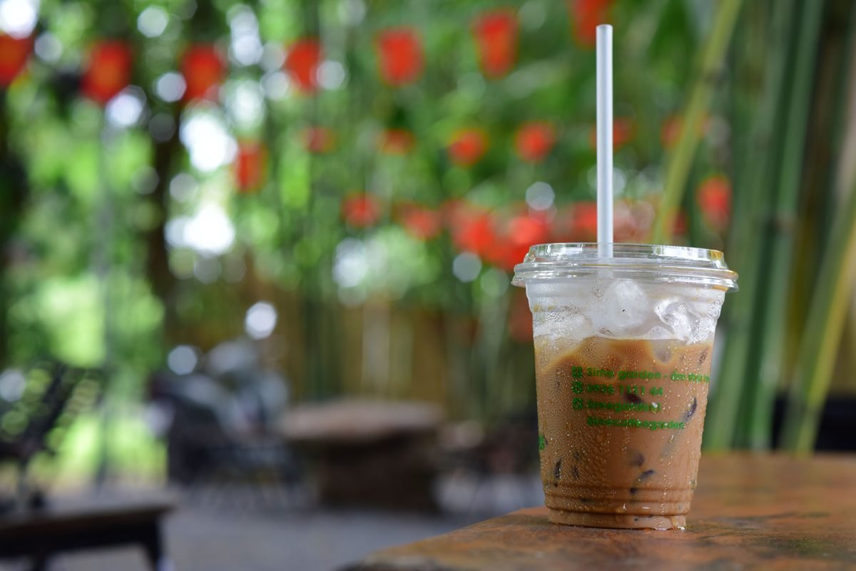 Iced coffee in a plastic cup with a straw