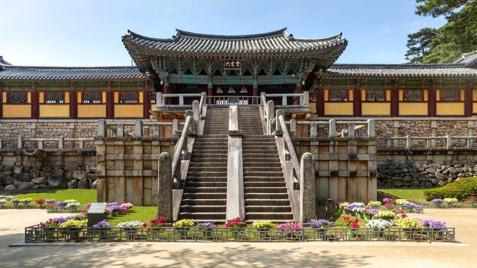 Bulguksa temple entrance gate stairs flower bed and blue sky in Gyeongju South Korea