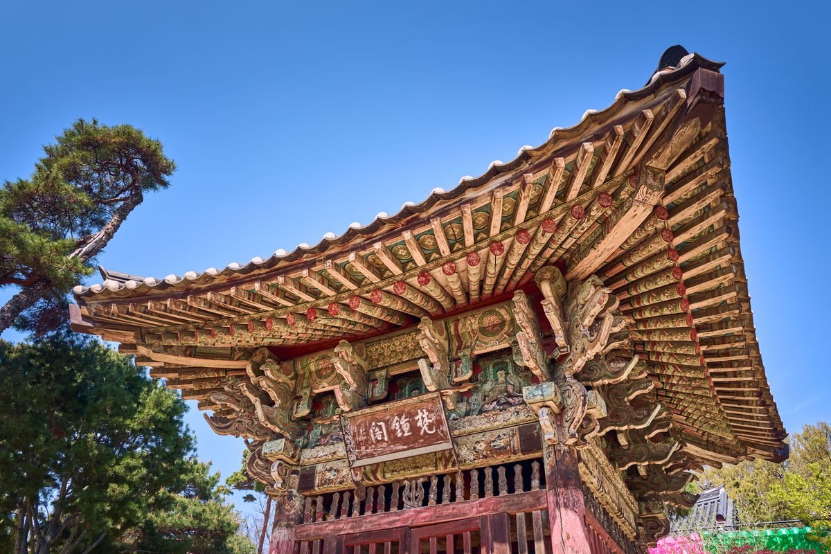 Detailed view of a traditional Korean temple roof showcasing intricate carvings