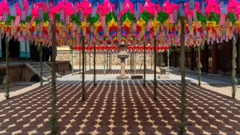 Courtyard of colorful paper lanterns and shadow patterns at Bulguksa temple in Gyeongju.