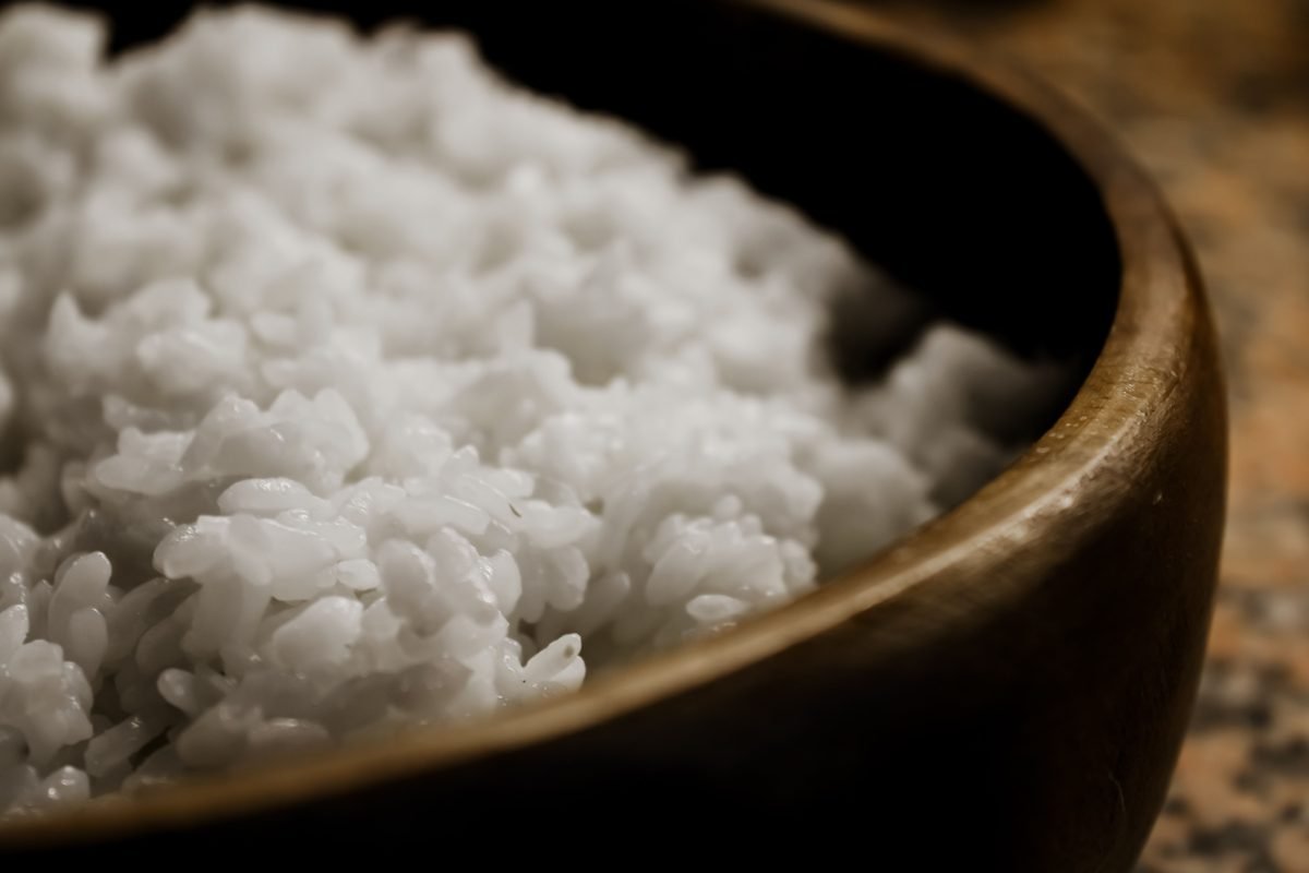 Close-up view of freshly steamed white rice in a wooden bowl
