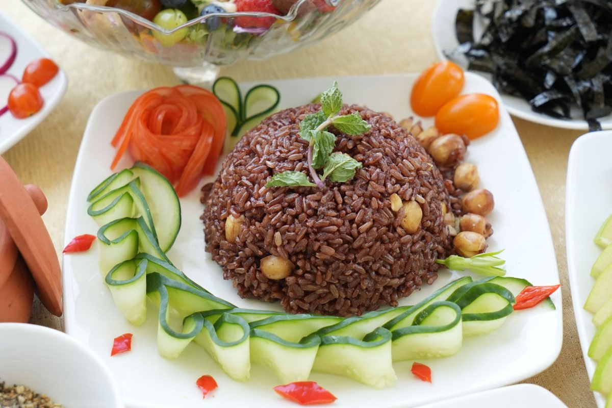Appetizing brown rice garnished with fresh vegetables