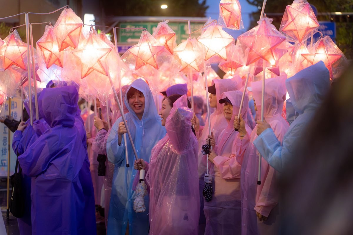 Vibrant lantern parade in Seoul featuring people holding glowing star lanterns