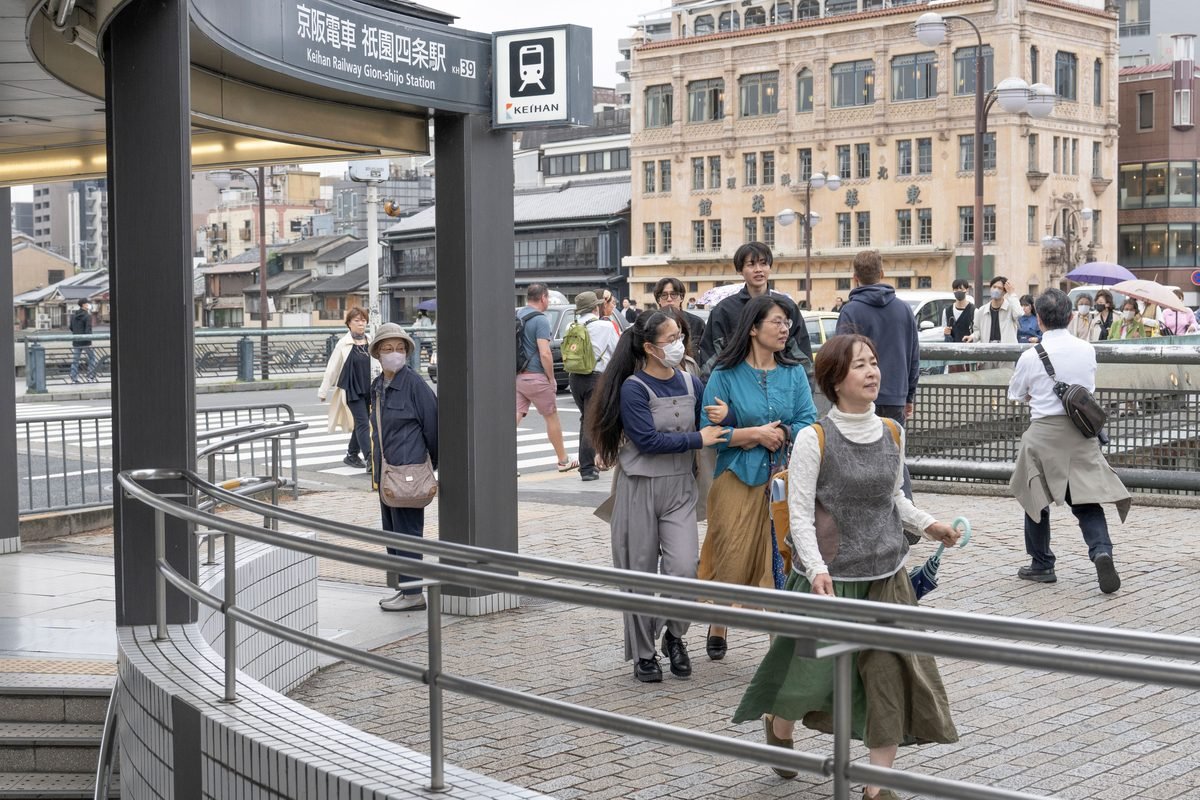 Commuters outside Keihan Railway Gion-shijo Station in Kyoto.
