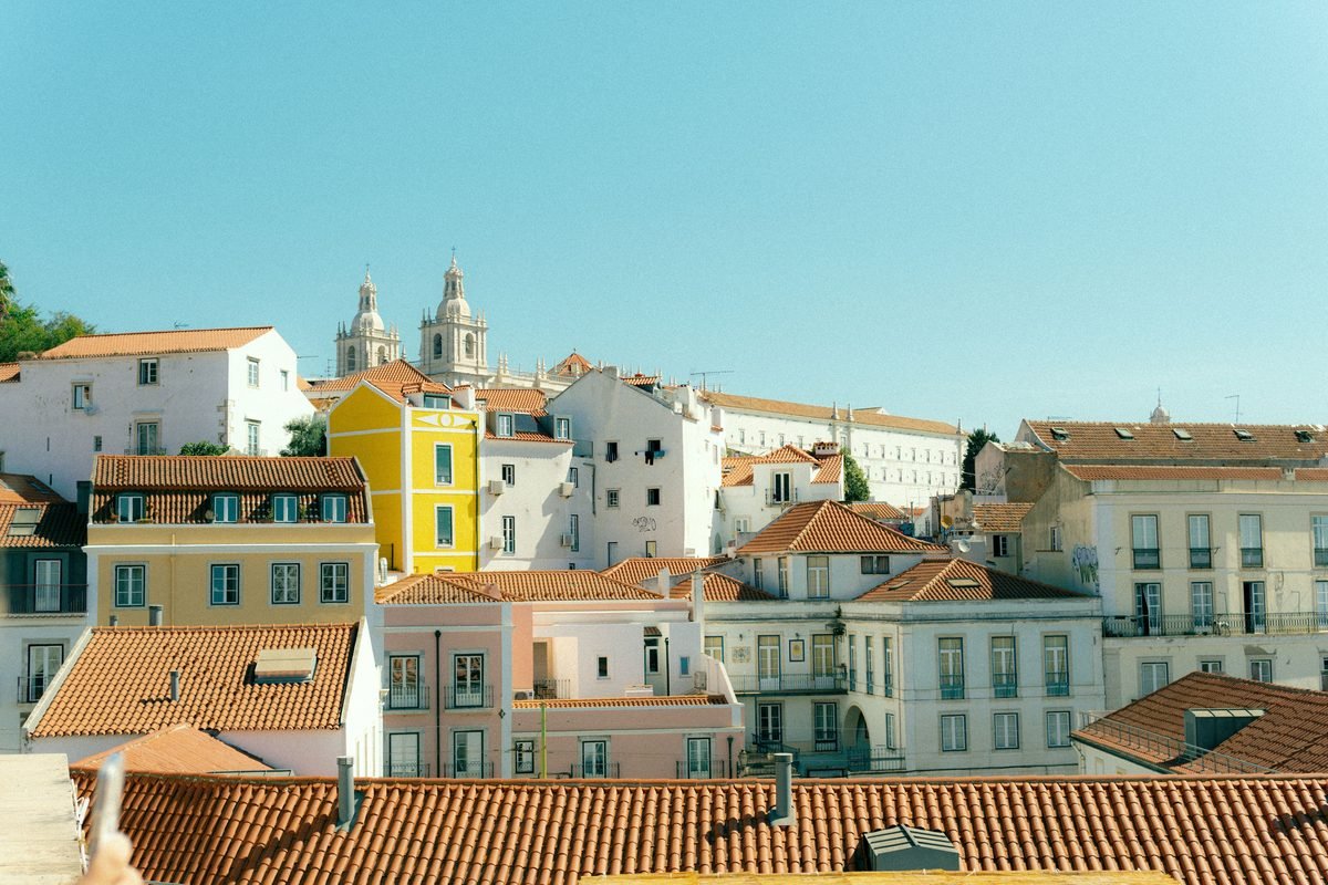 Charming view of Lisbon rooftops and historic architecture on a sunny day.