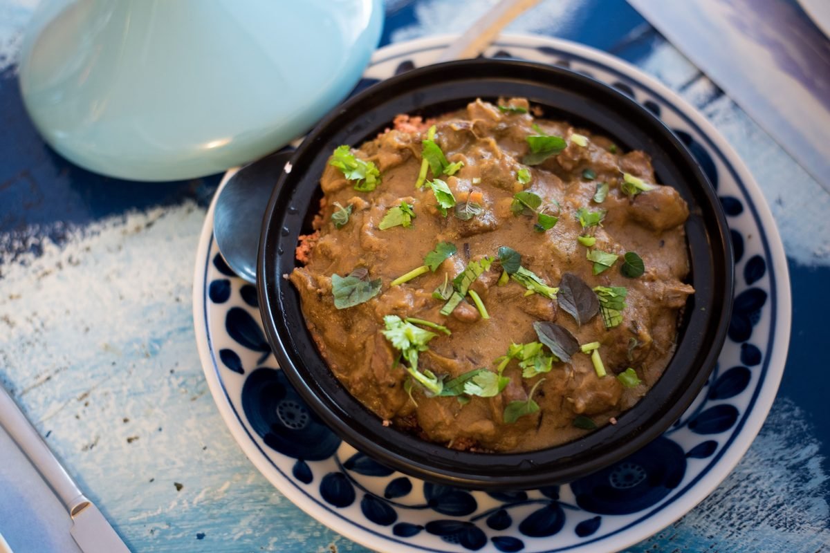 Savory Moroccan tagine garnished with fresh herbs