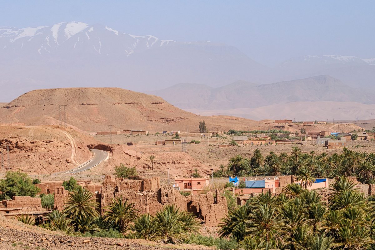 Moroccan landscape with Atlas Mountains and palm trees