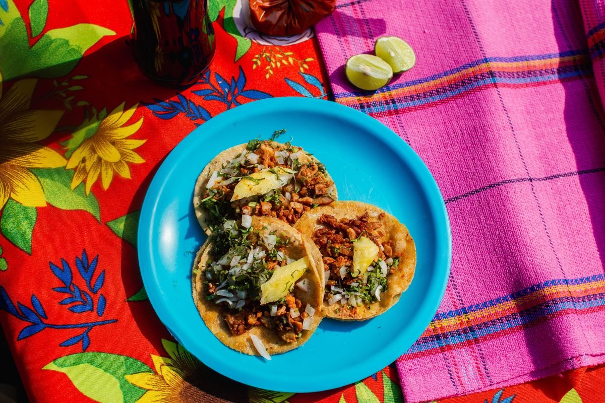 Mexican tacos with toppings on a colorful table setting
