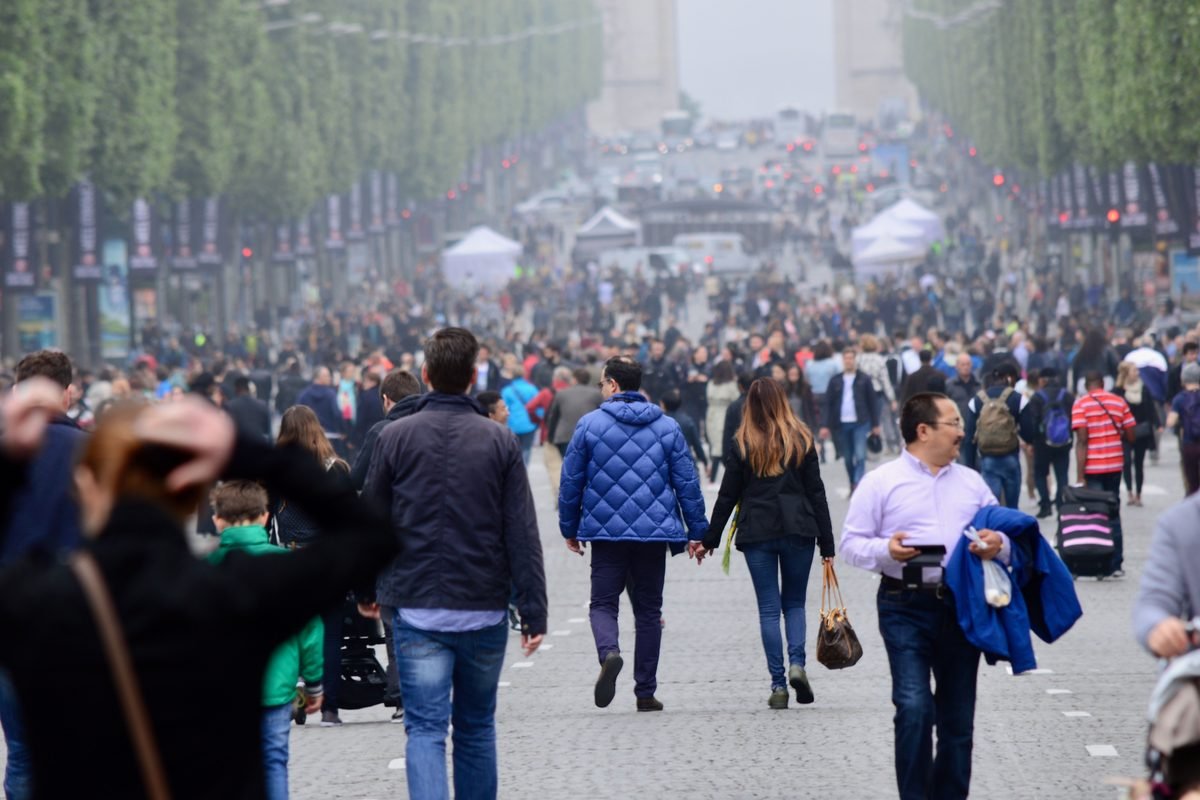 Crowded Champs-Élysées in Paris with pedestrians and traffic