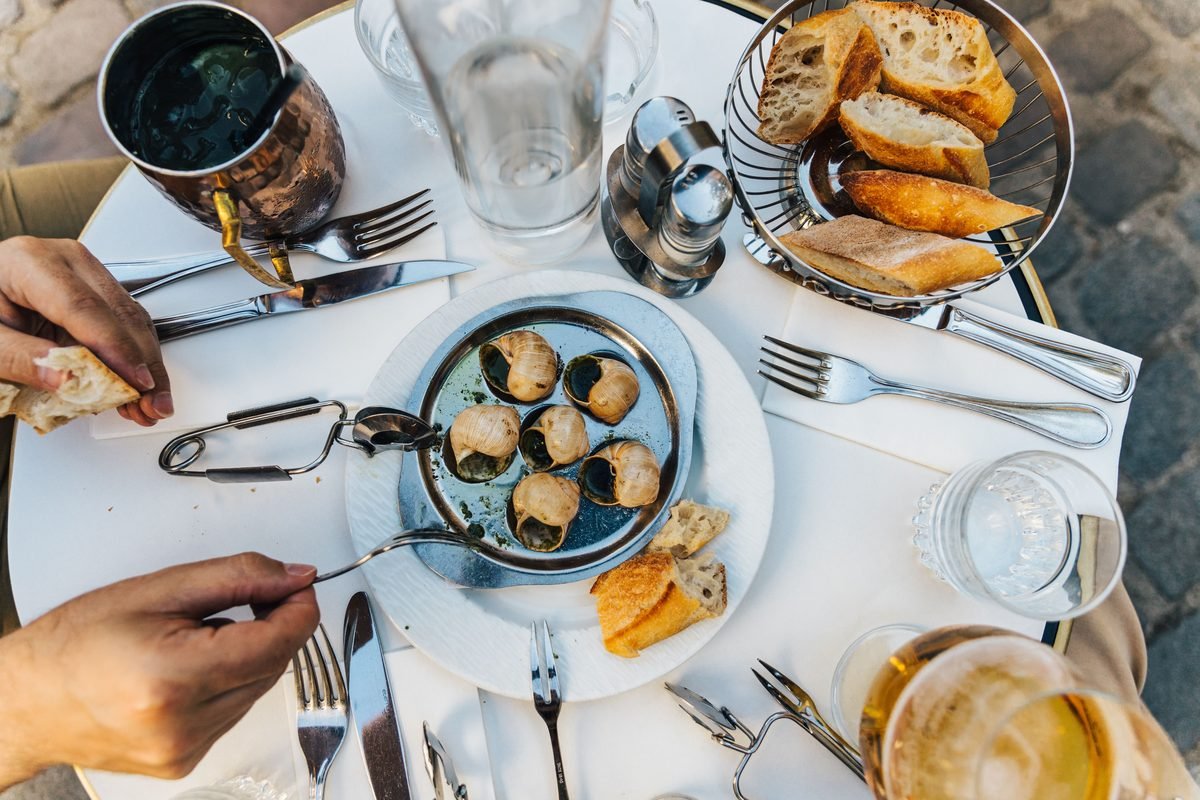 Classic French dining experience with escargot and baguette in Paris