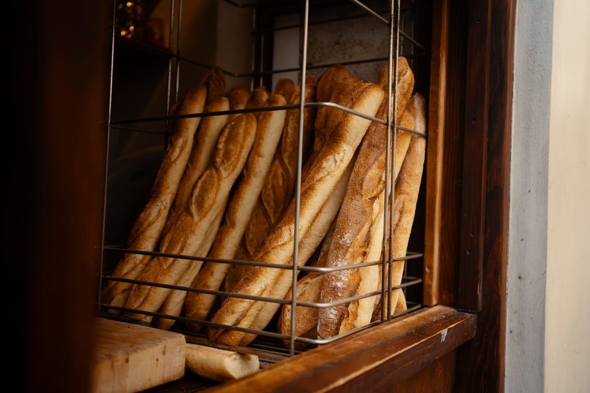 Fresh baguettes stacked in a rustic bakery display
