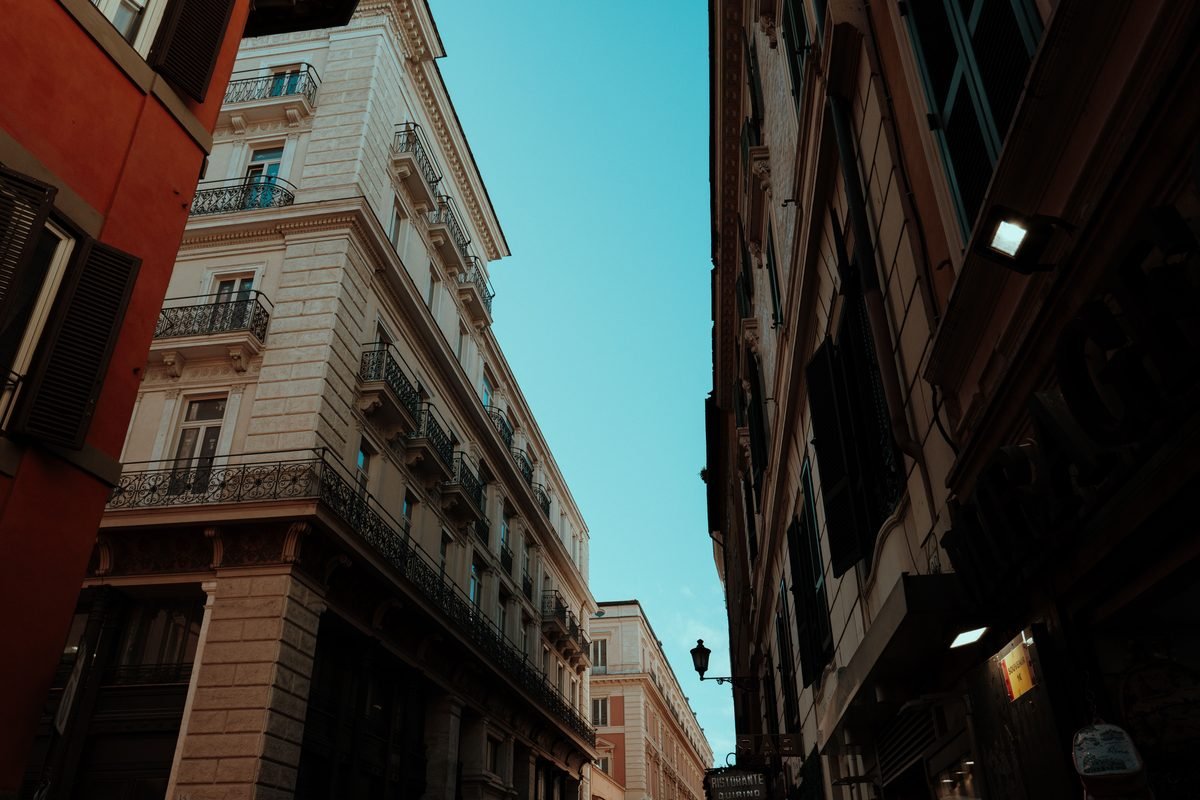 Quaint European street featuring classic architecture under clear blue skies.