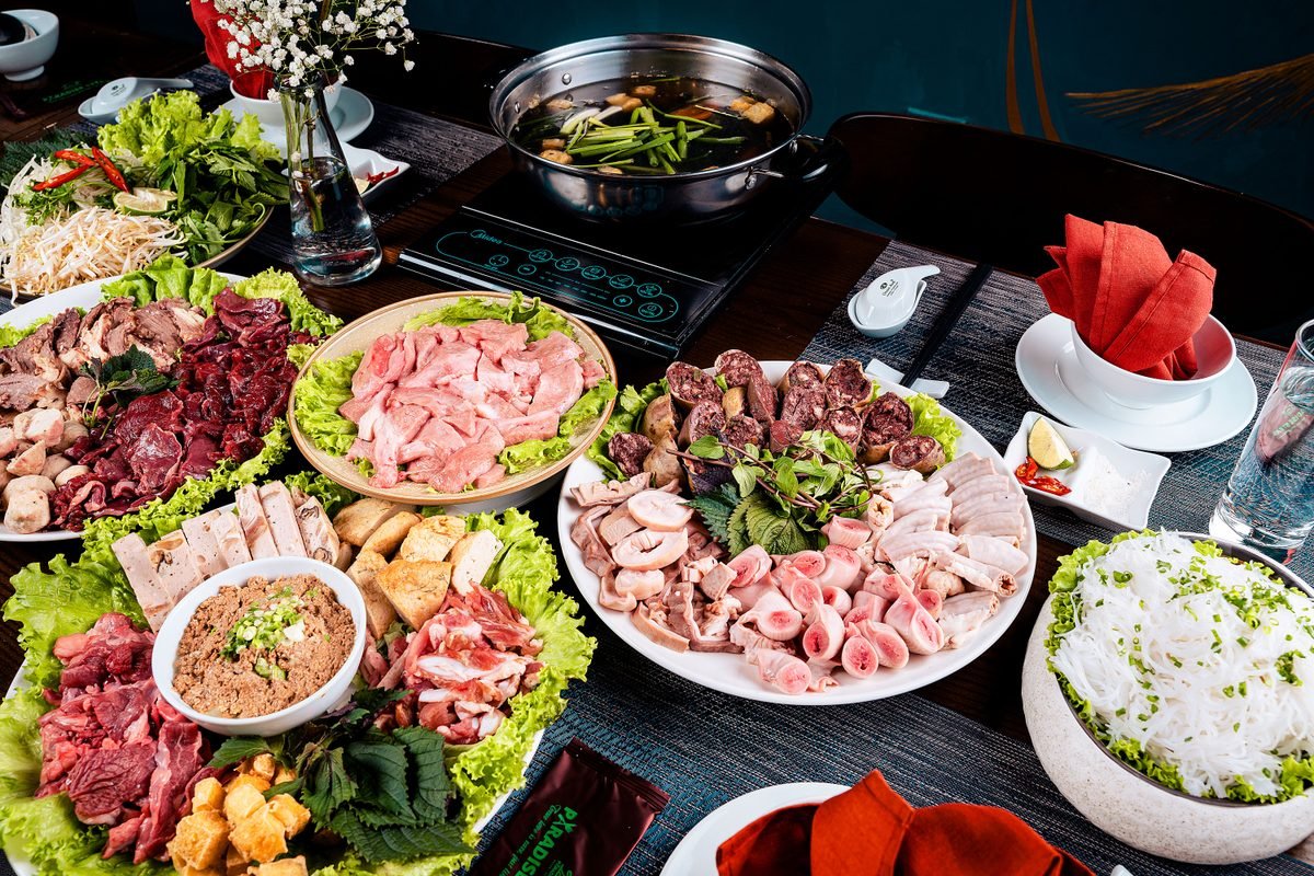 Vibrant spread of ingredients for a traditional Vietnamese hot pot meal.