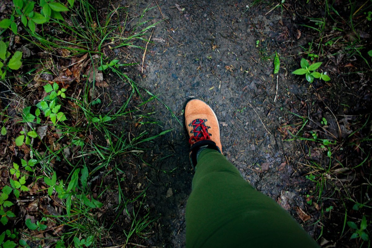 Close-up of a hiking boot on a dirt trail