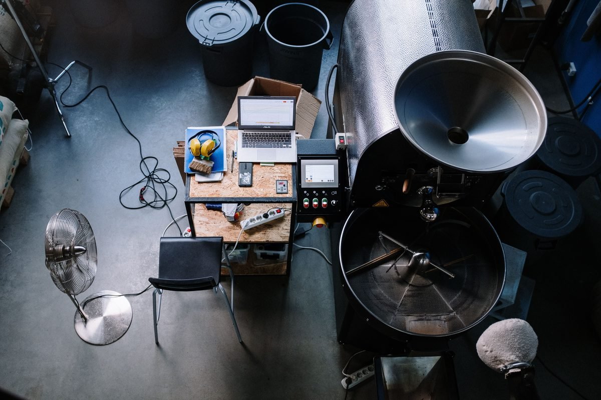 An overhead view of a coffee roastery workspace featuring equipment.