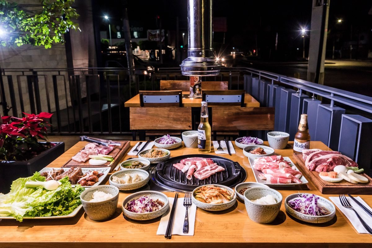 Korean BBQ spread with meats and vegetables for dining enthusiasts.
