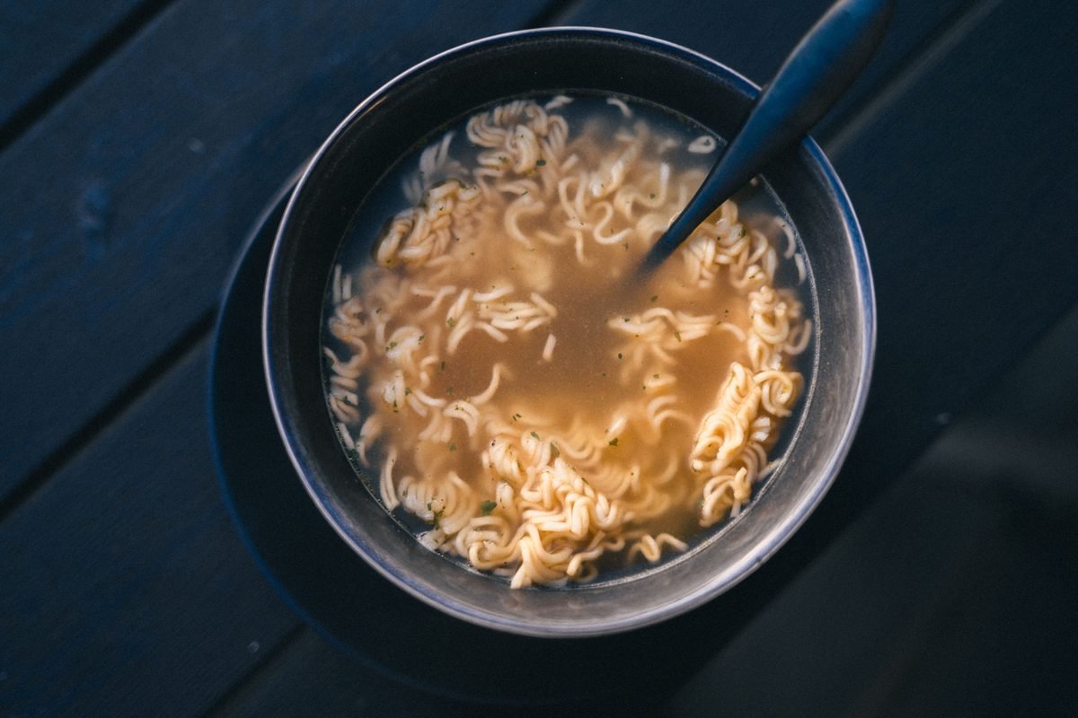 Close-up of a warm bowl of instant ramen noodles with broth.
