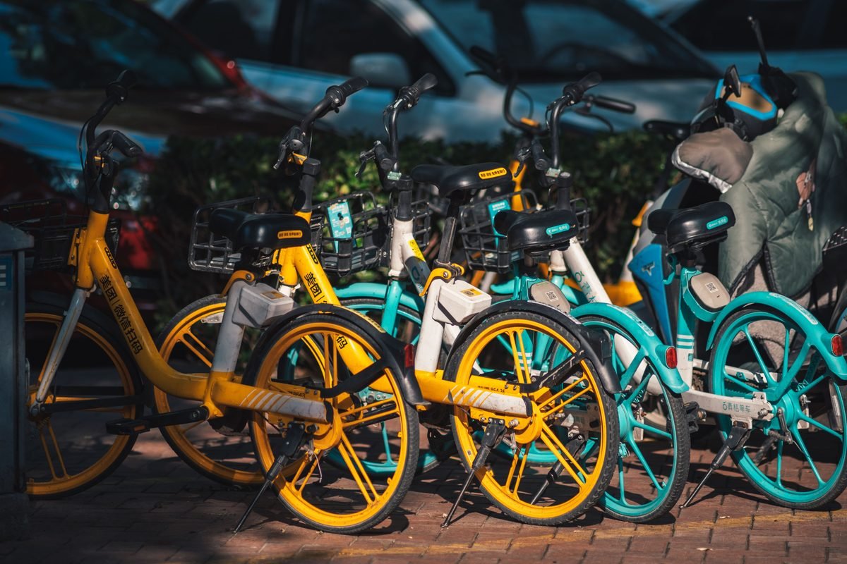 Row of colorful public rental bikes parked outdoors.