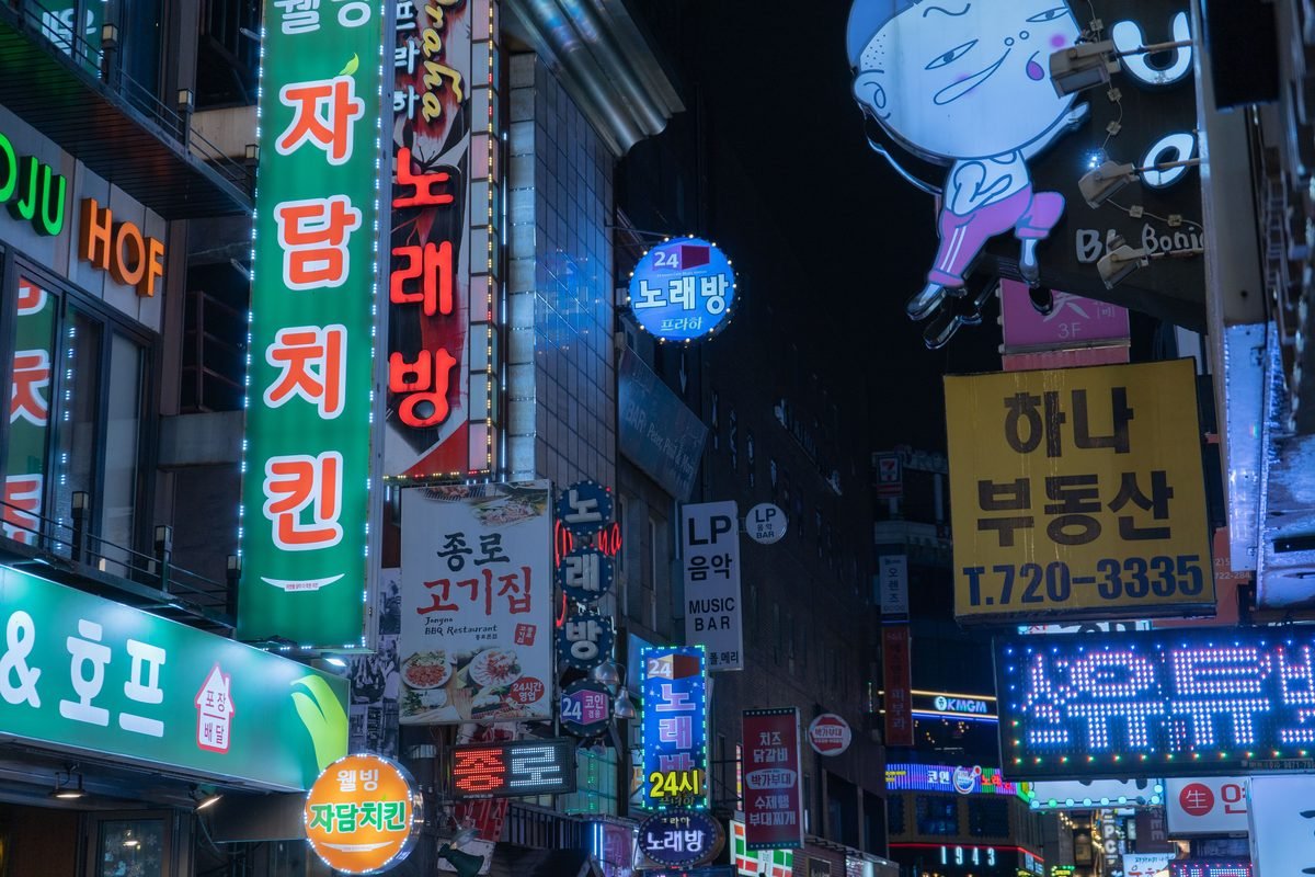 Vibrant neon signs and bustling night street scene in downtown Seoul