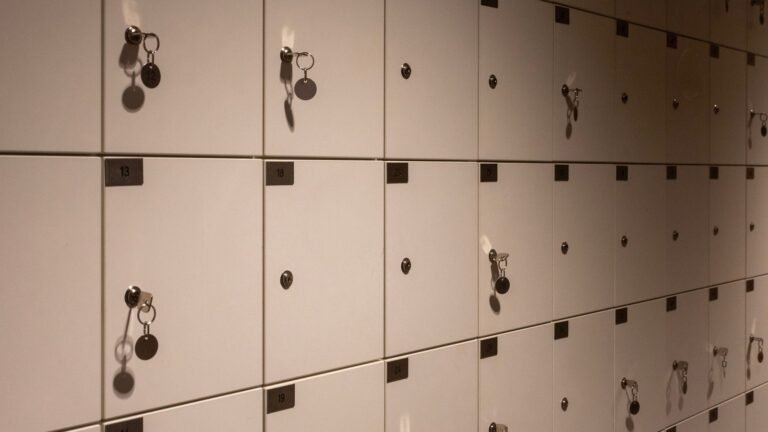 Close-up perspective of numbered white lockers with hanging keys