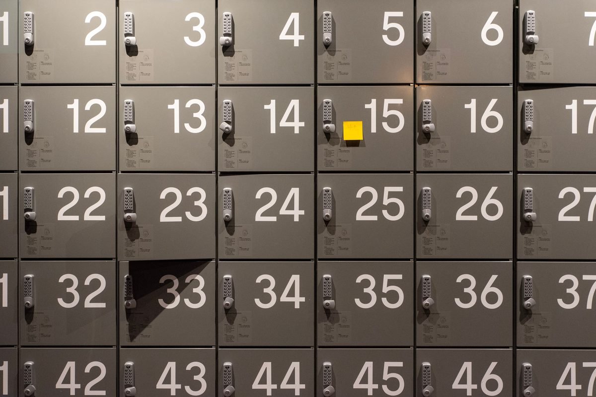 Gray storage lockers featuring digital keypads and clear numbering