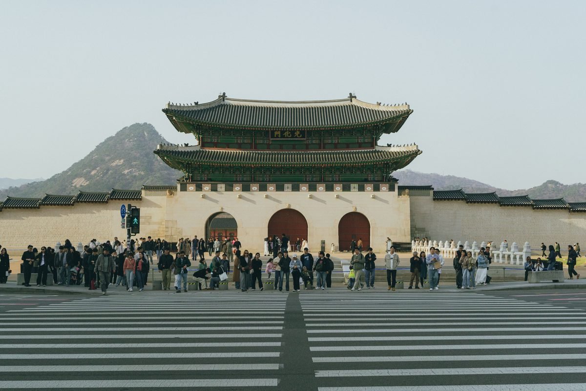 Gwanghwamun Gate with a gathered crowd in Seoul, South Korea.