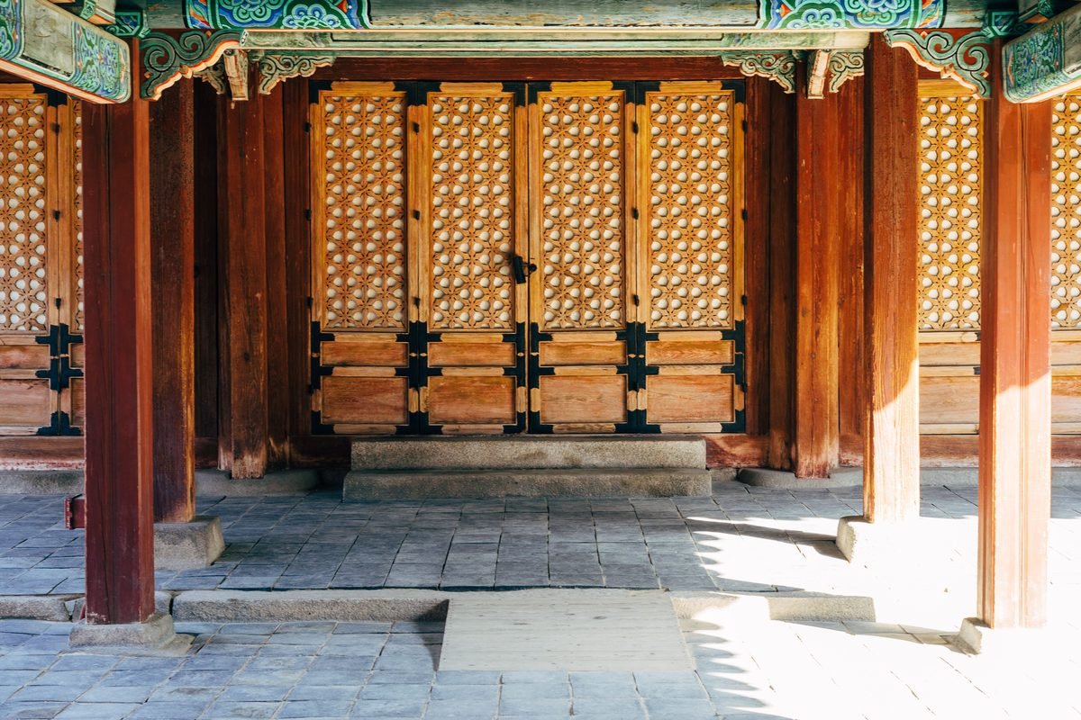 Beautiful wooden doors of a traditional Korean palace entrance in Seoul.