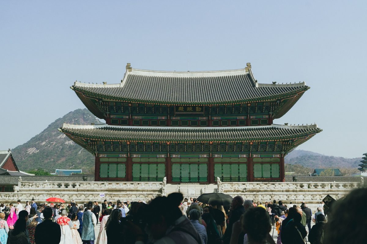 Traditional Korean architecture of Gyeongbokgung Palace in Seoul with crowds gathered in front