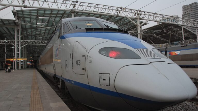 Silver KTX high-speed train stopped at Seoul station platform in South Korea.