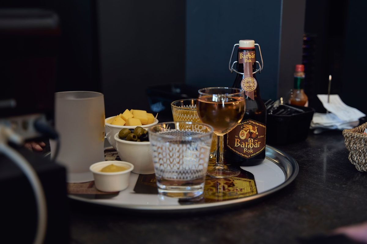 Tray with drinks and snacks in a tavern setting.