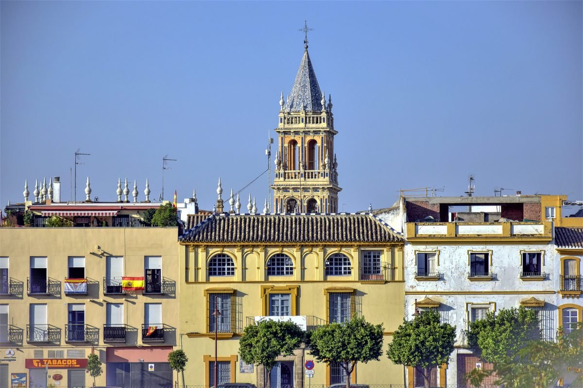Giralda tower rising above residential buildings in Seville.