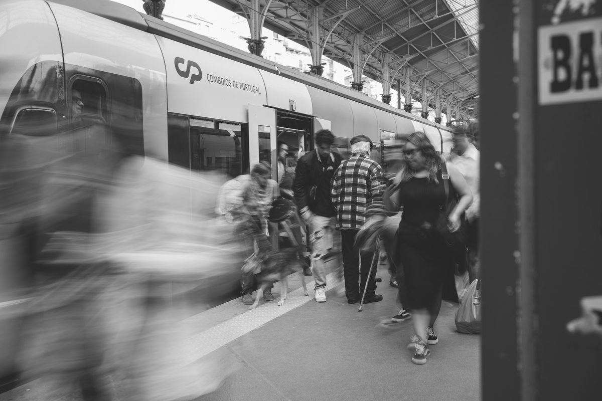 Commuters boarding a Portuguese train at a station