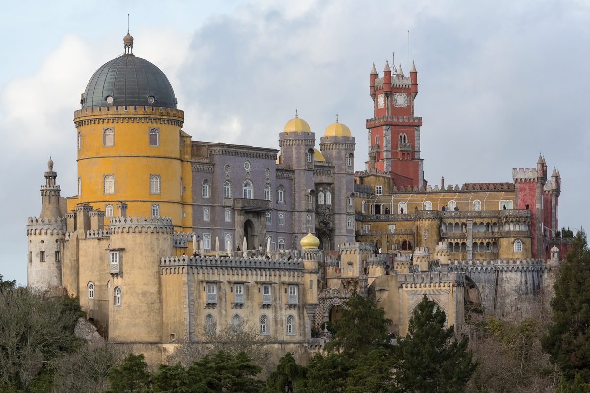 Detailed view of the colorful yellow and red turrets of Pena Palace