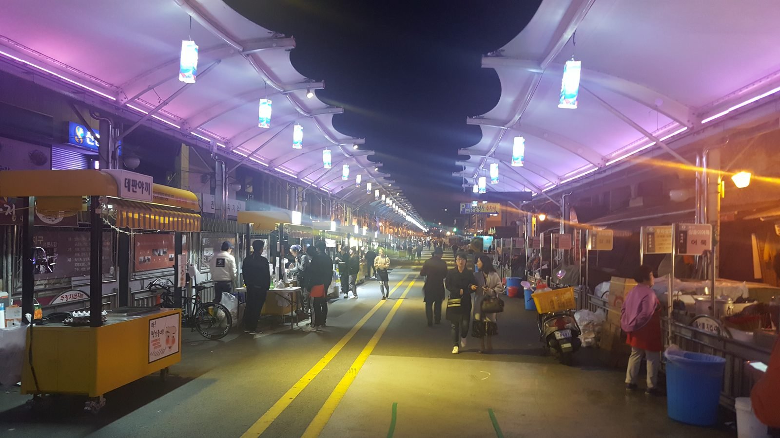 Seomun Night Market in Daegu with yellow food stalls and warm lighting