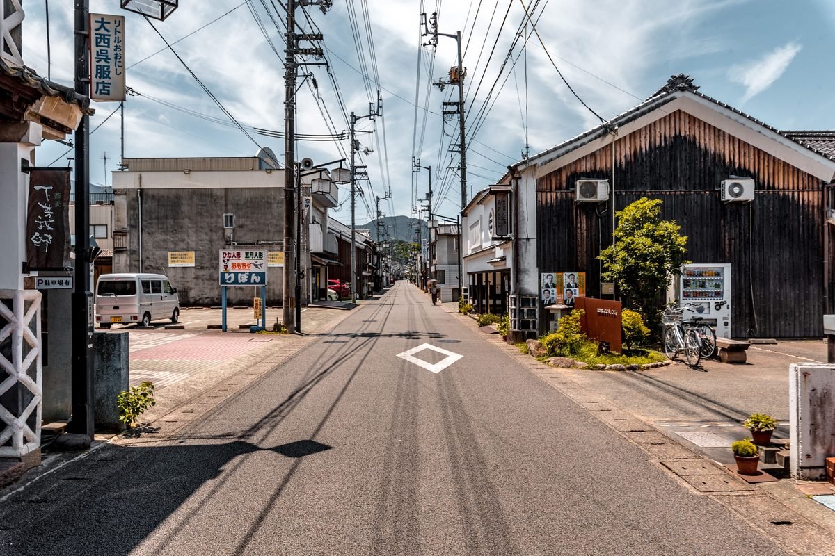 Traditional Japanese street with vintage buildings and parked bicycle.