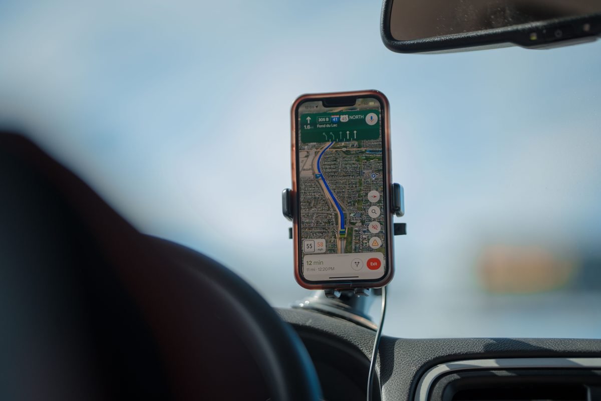 Smartphone with GPS navigation app mounted on a car dashboard