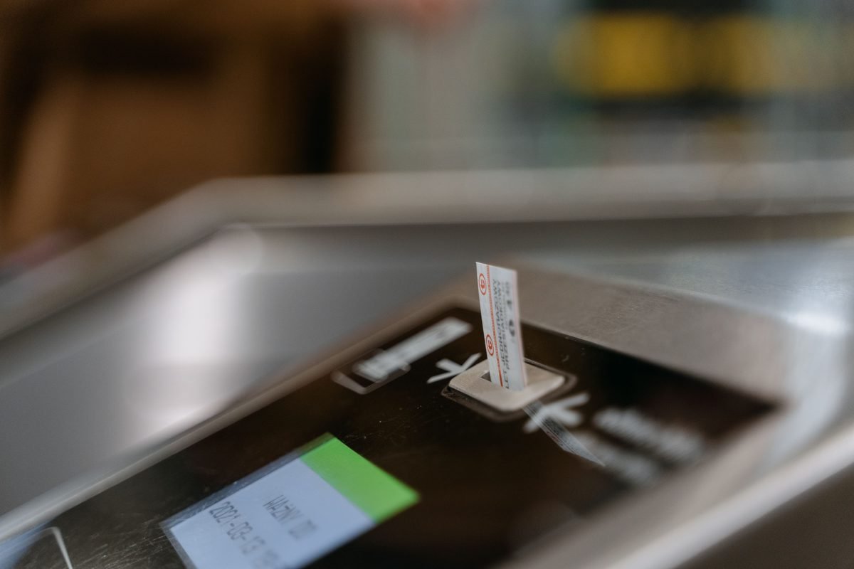 Close-up of a subway ticket machine with a ticket inserted