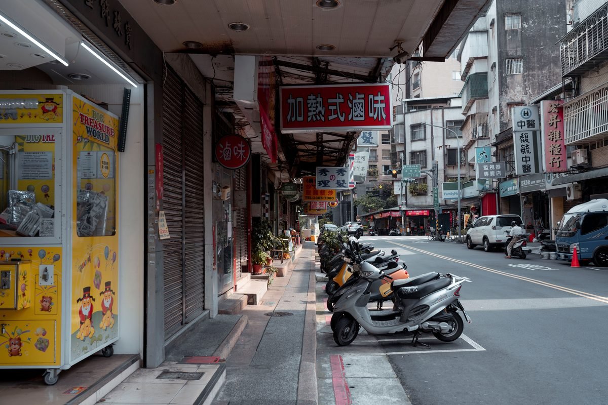 City street with parked scooters and vibrant storefronts