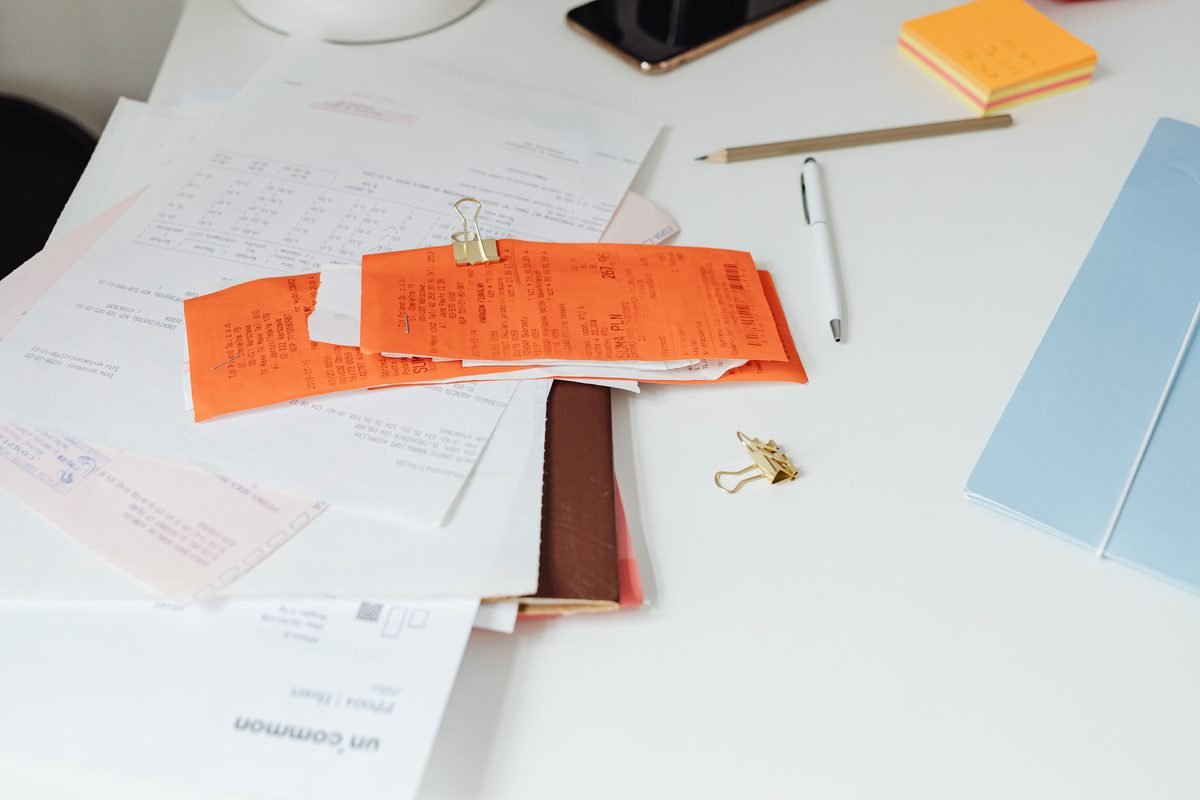 Close-up of a tidy desk with receipts and documents