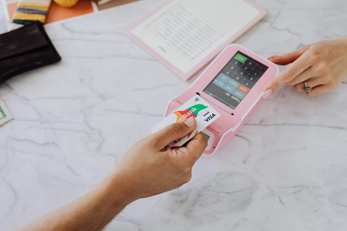 Contactless payment using credit card and pink terminal