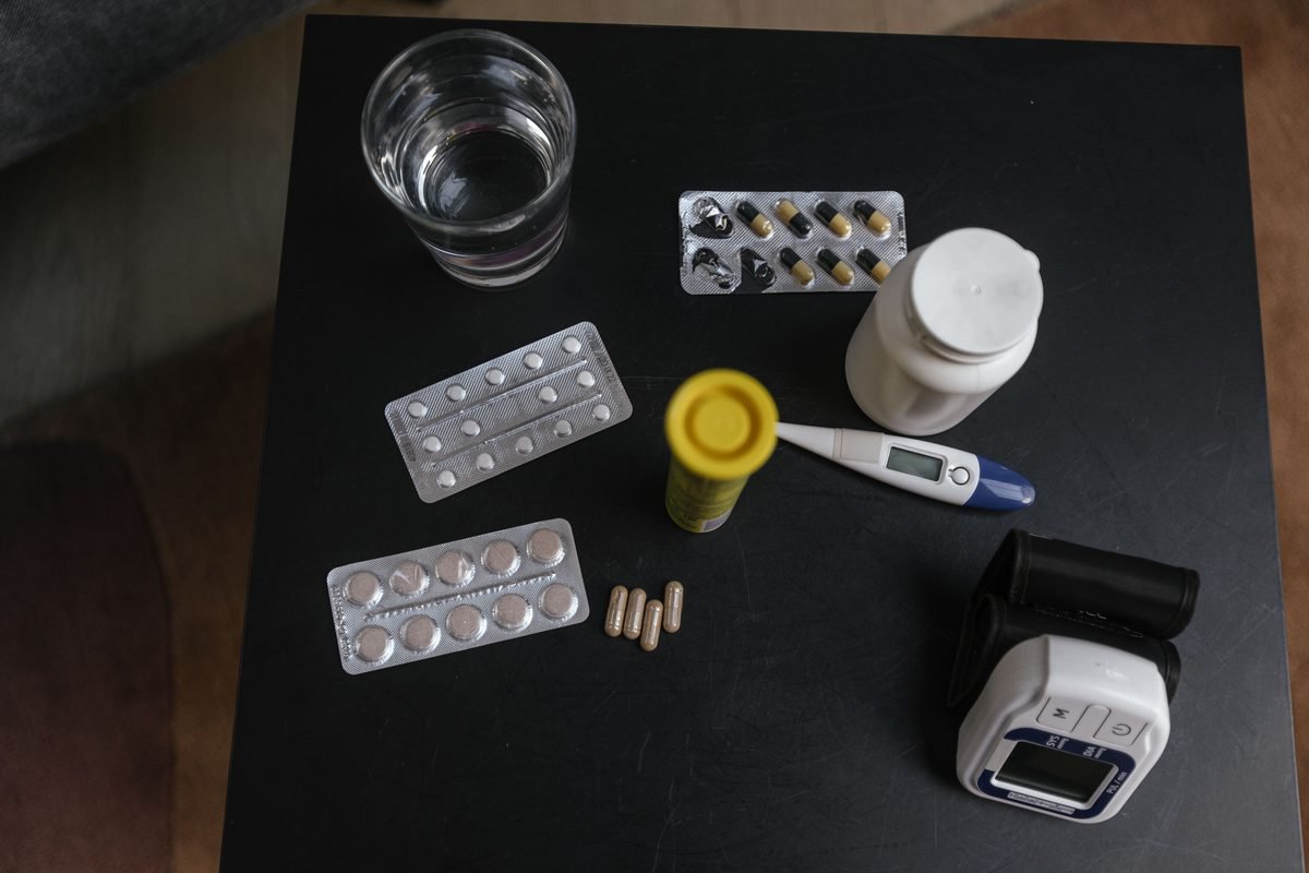Top view of various medications and medical devices on a table