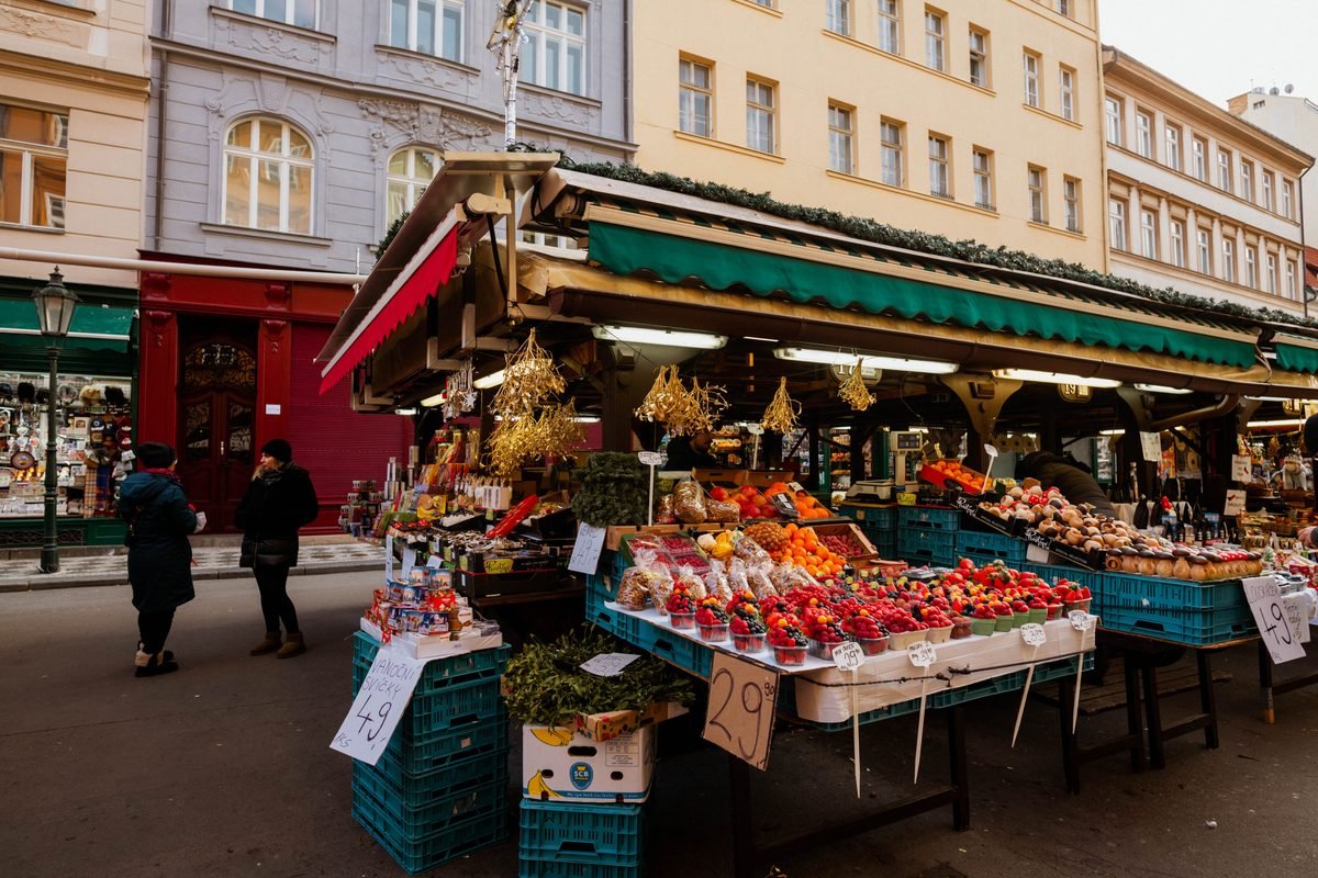 Lively outdoor market stall loaded with fresh produce and fruits.