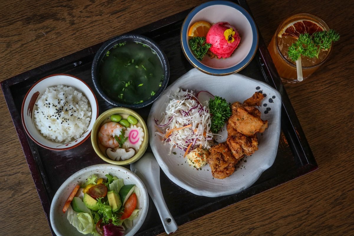 Traditional Japanese set meal tray featuring rice, soup, salad, and fried dishes