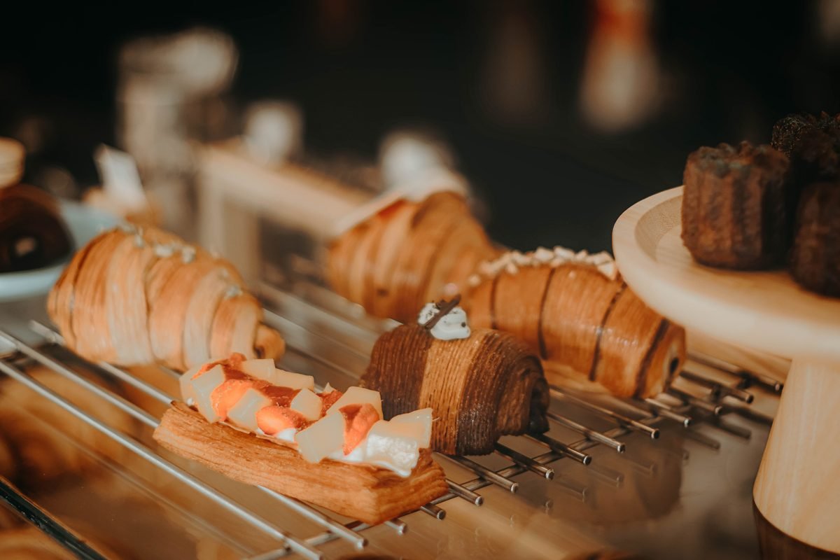 Gourmet pastries and croissants displayed on a rack.