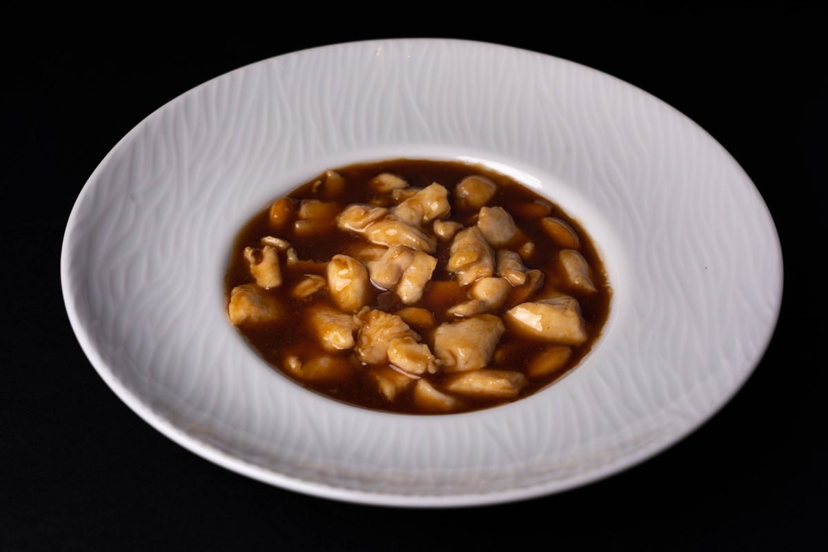 Close-up of a savory Chinese chicken dish with almonds.