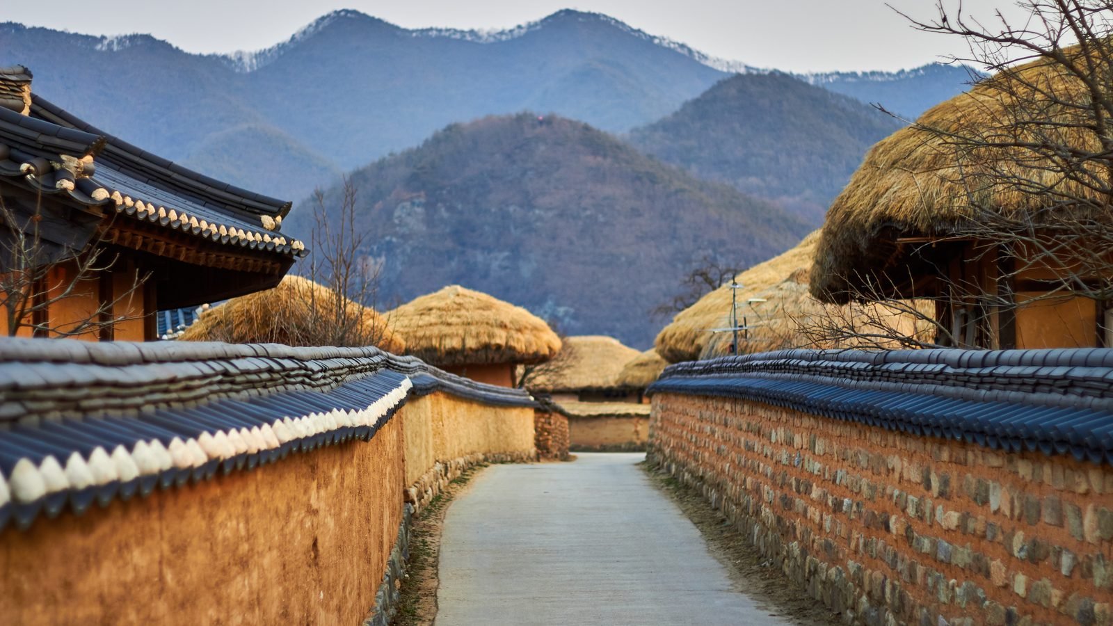 Traditional village street with mountains in the background